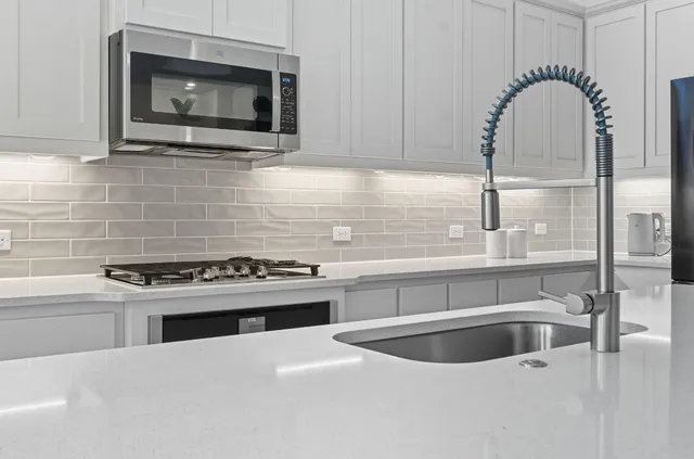 a kitchen with a stove a sink and a microwave