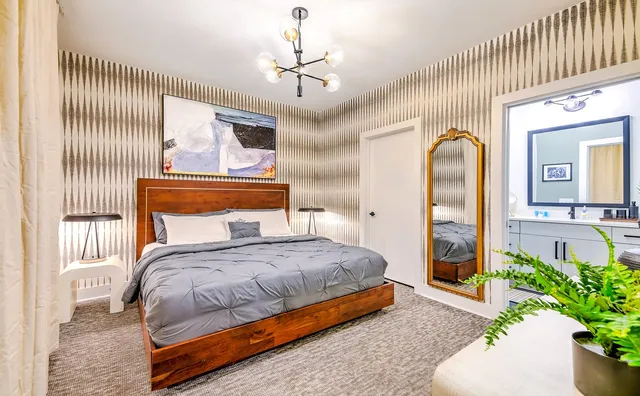 a bedroom with a bed and a chandelier