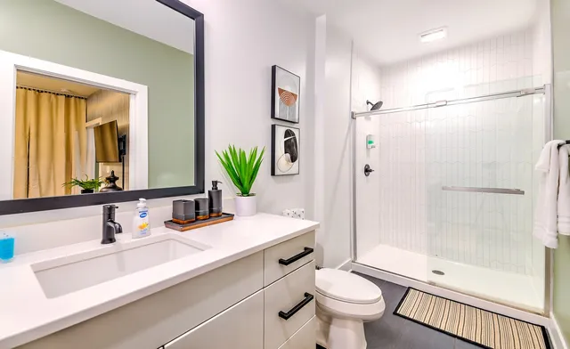 a bathroom with a sink toilet and shower