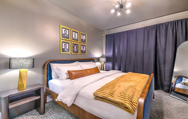 a bedroom with bed and wooden floor