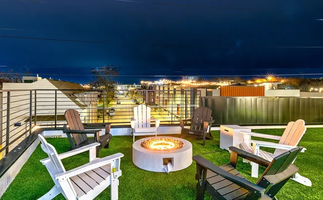 a view of a chairs in backyard of house