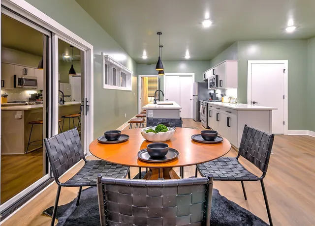 a dining room with furniture and wooden floor