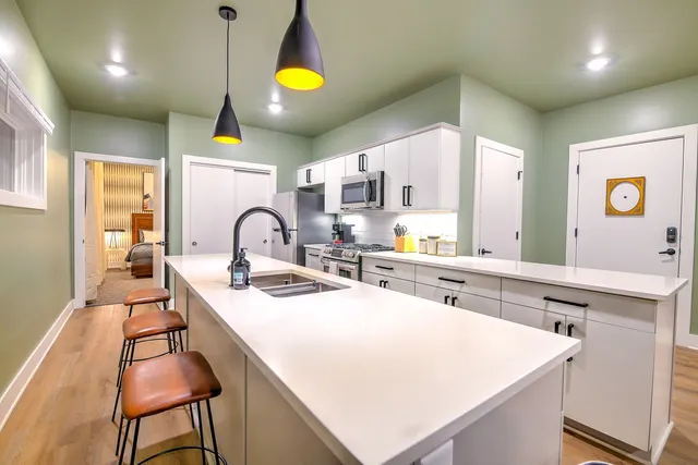 a kitchen with a sink a counter space and cabinets