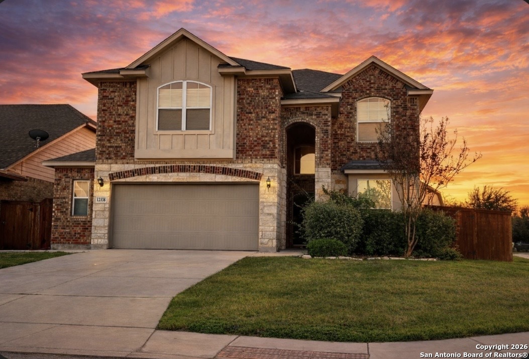 a front view of a house with a yard and garage