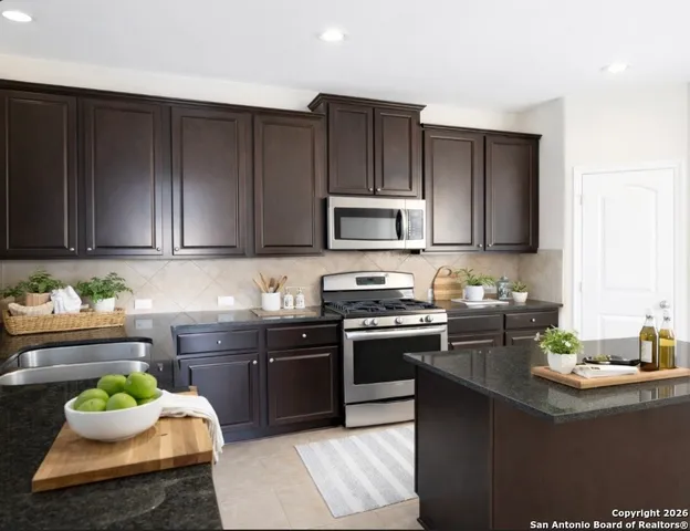 a kitchen with wooden cabinets and sink