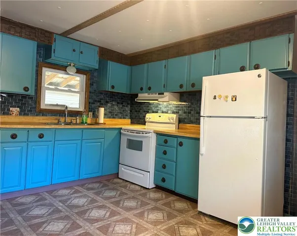 a kitchen with a refrigerator and a sink