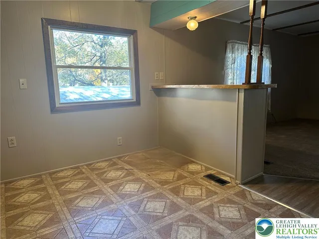 a view of a room with wooden floor and windows