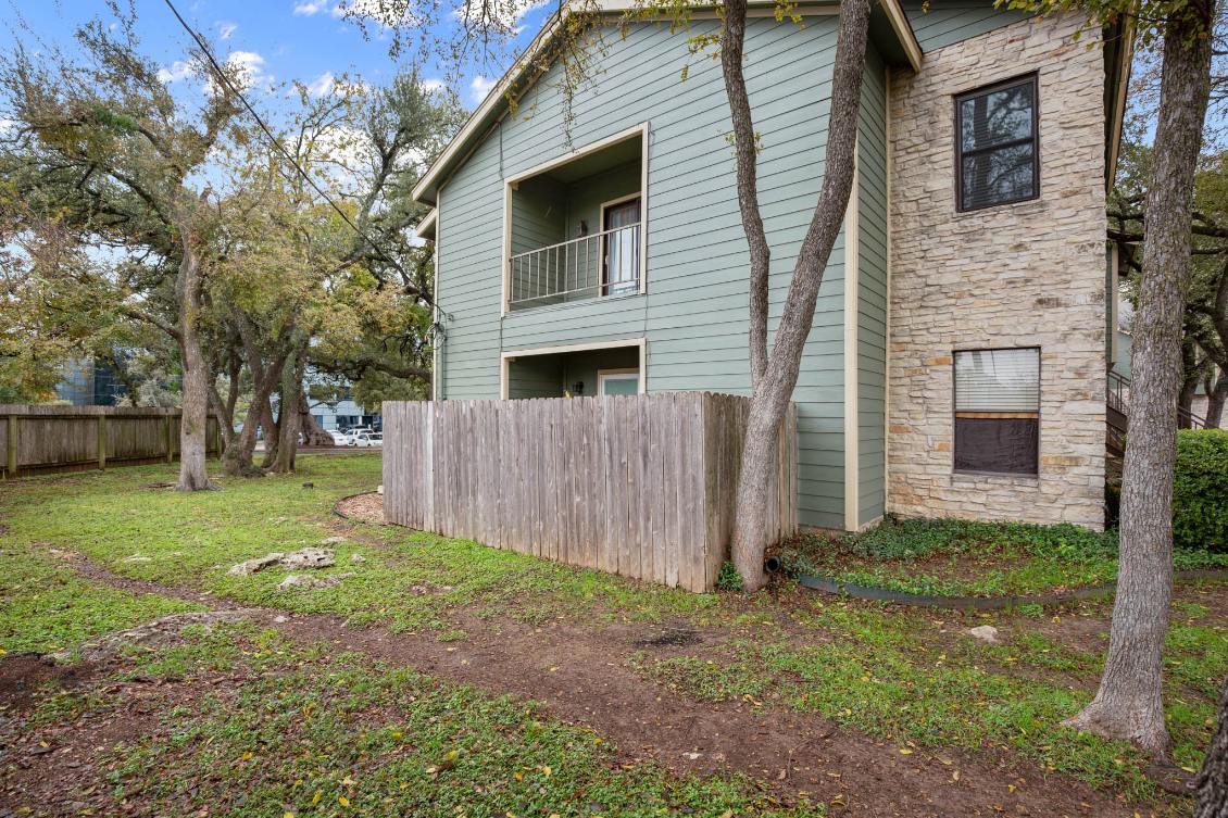 View of home's exterior with stone siding and a balcony