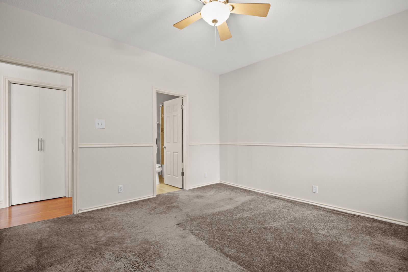 11970 Jollyville Road, Unit 216 Austin, TX 78759 - Photo 14 of 20 Unfurnished bedroom featuring light carpet and a ceiling fan