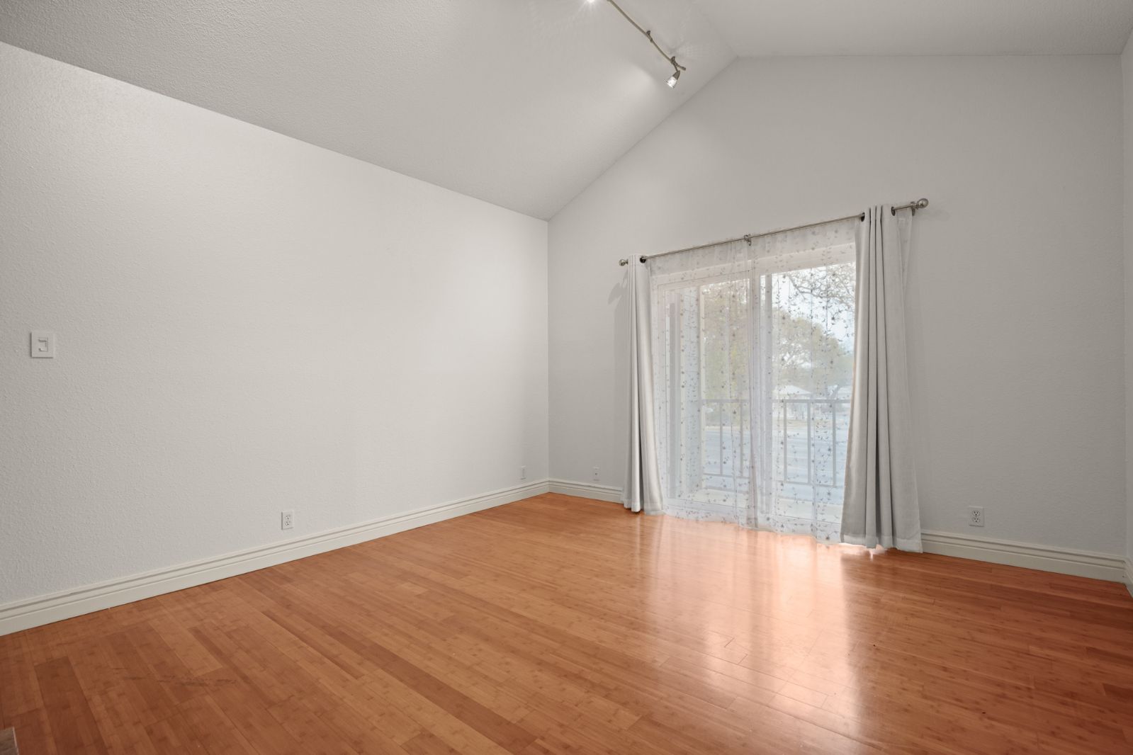 11970 Jollyville Road, Unit 216 Austin, TX 78759 - Photo 18 of 20 Spare room with light wood-style flooring, lofted ceiling, and track lighting