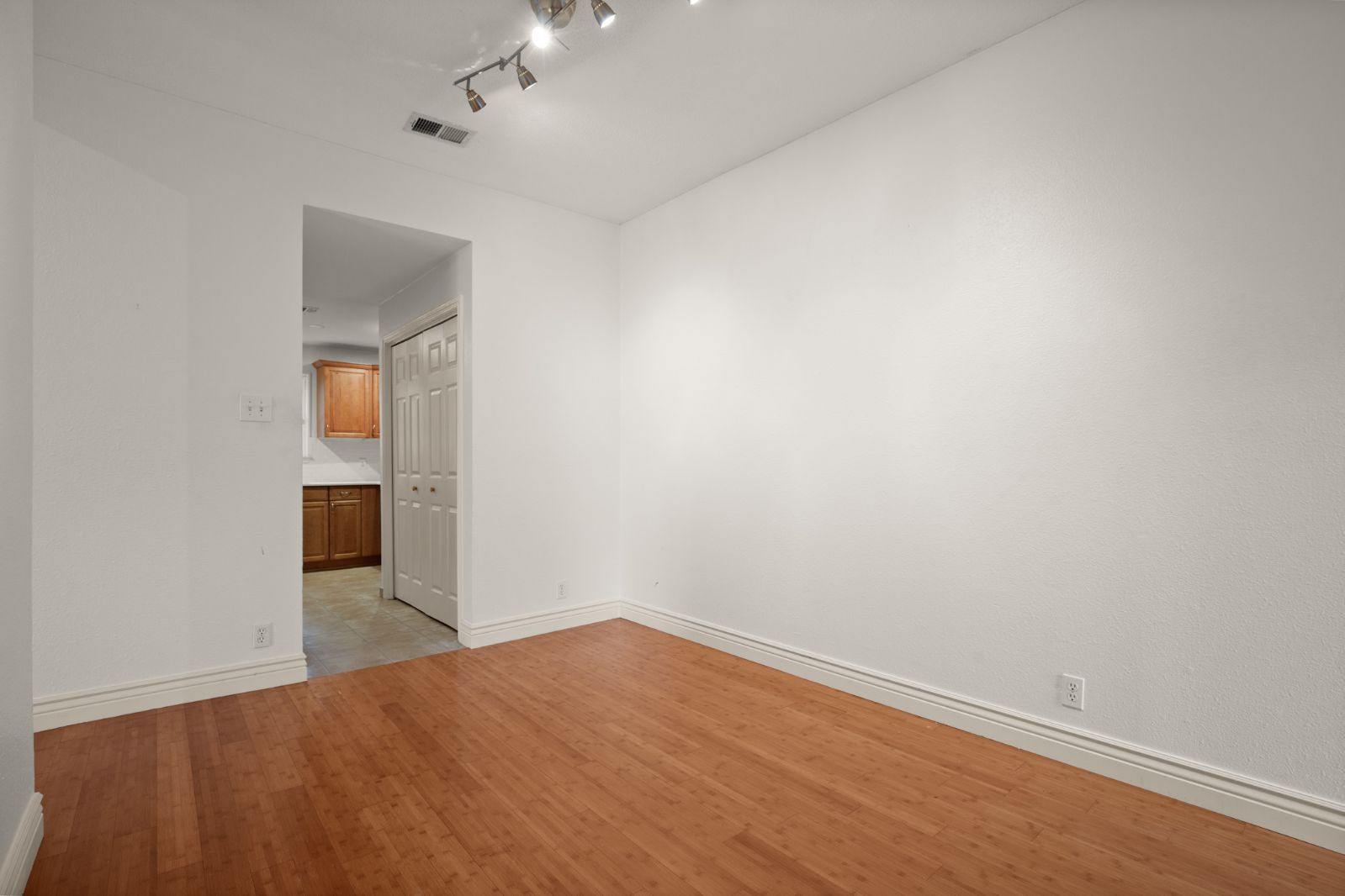 11970 Jollyville Road, Unit 216 Austin, TX 78759 - Photo 8 of 20 Empty room featuring light wood-style flooring and baseboards
