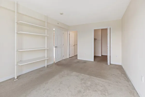 a view of an empty room with a closet