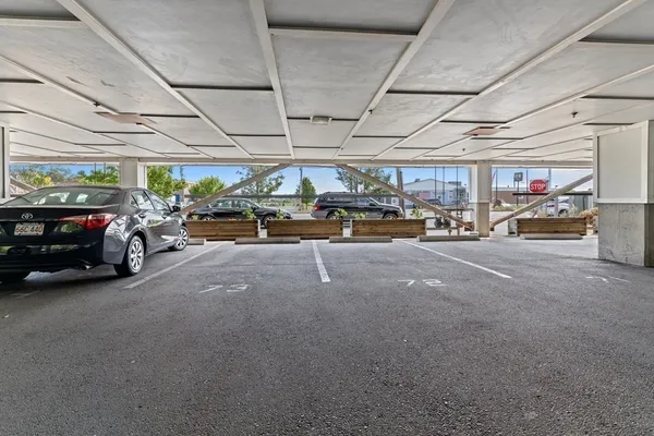 a view of parking garage with cars