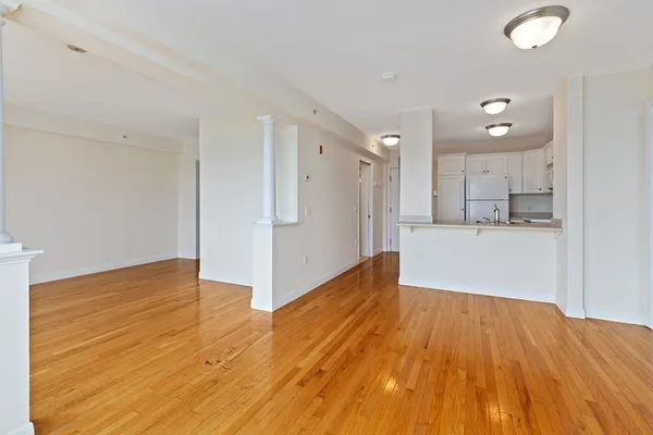 a view of a kitchen with wooden floor and a sink