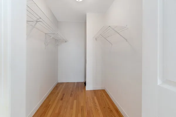 a view of a room with wooden floor