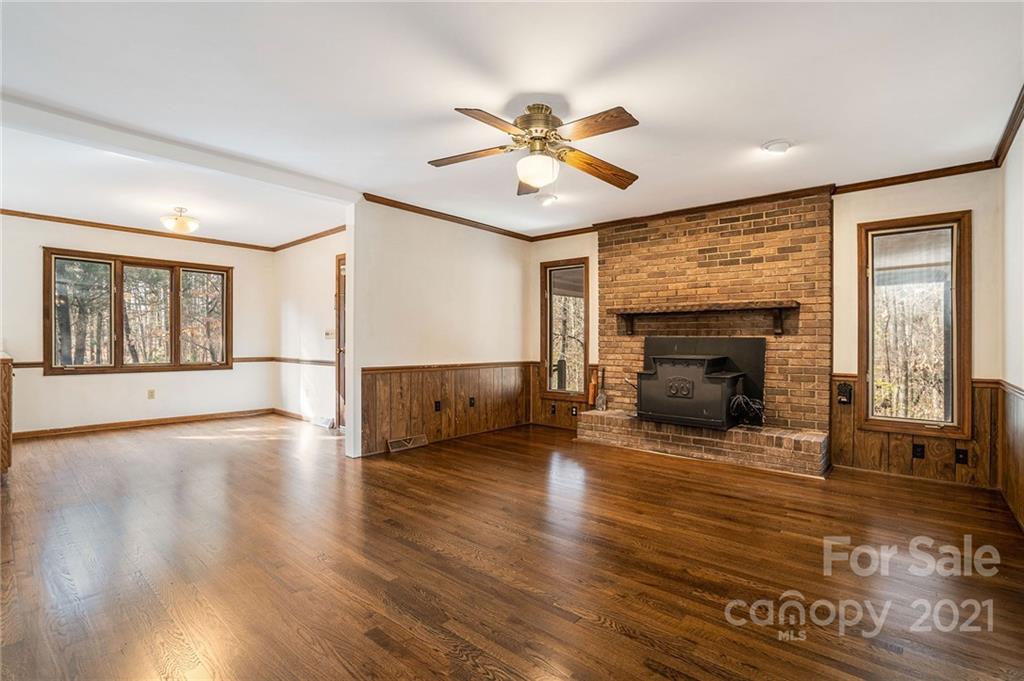3903 Tater Ridge Road Concord, NC 28025 - Photo 11 of 34 a view of an empty room with wooden floor fireplace and a window