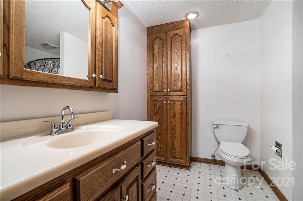 3903 Tater Ridge Road Concord, NC 28025 - Photo 17 of 34 a bathroom with a sink a toilet a mirror and shower