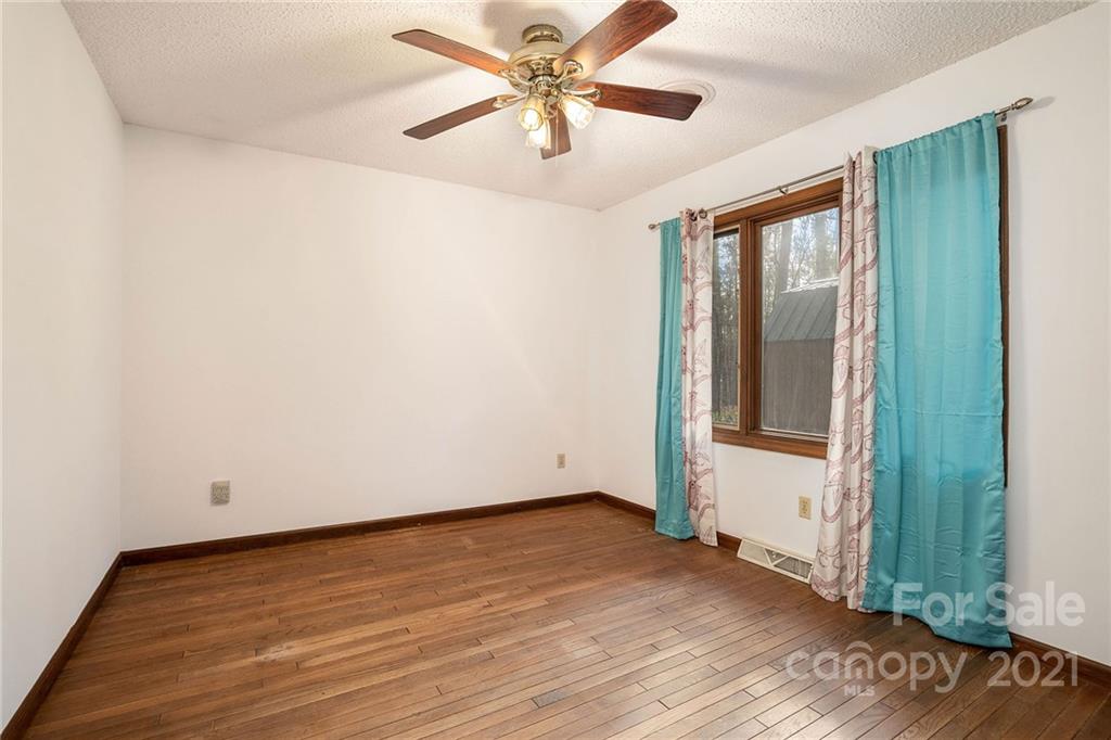 3903 Tater Ridge Road Concord, NC 28025 - Photo 19 of 34 an empty room with wooden floor and fan