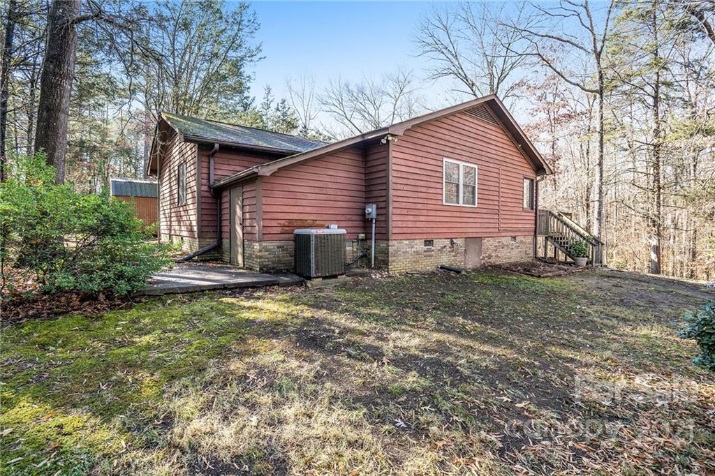 3903 Tater Ridge Road Concord, NC 28025 - Photo 23 of 34 a view of a house with a small yard plants and large tree