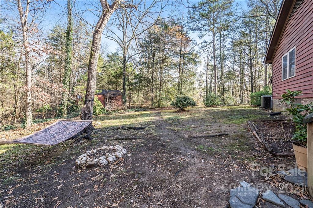 3903 Tater Ridge Road Concord, NC 28025 - Photo 24 of 34 a view of a yard with lots of trees