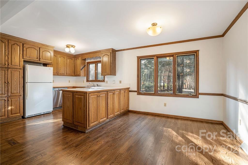 3903 Tater Ridge Road Concord, NC 28025 - Photo 6 of 34 a large white kitchen with a refrigerator a stove a sink and a window