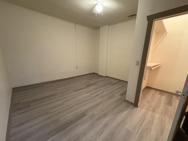 4876 East Williams Spring Road Fort Worth, TX 76135 - Photo 13 of 20 an empty room with wooden floor and a window