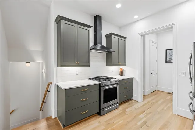 a kitchen with stainless steel appliances granite countertop a stove and a refrigerator