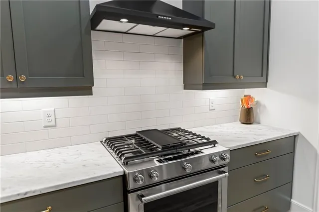 a kitchen with stainless steel appliances granite countertop a sink and a stove
