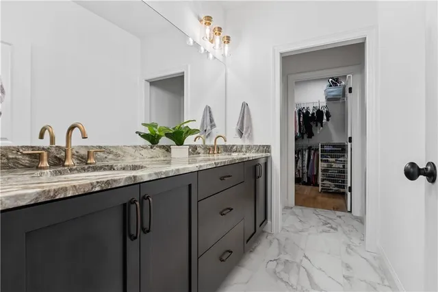 a bathroom with a double vanity sink and a mirror