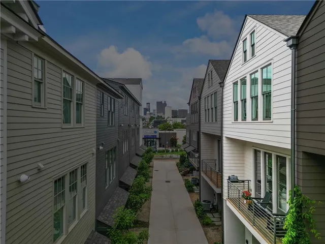 a view of a house with swimming pool and sitting area
