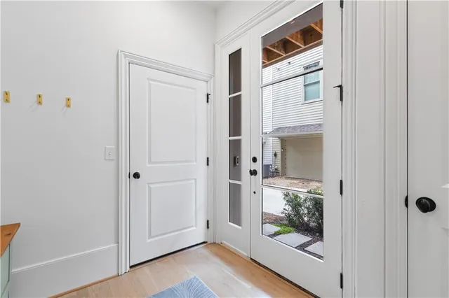 a view of a hallway with wooden floor and entryway