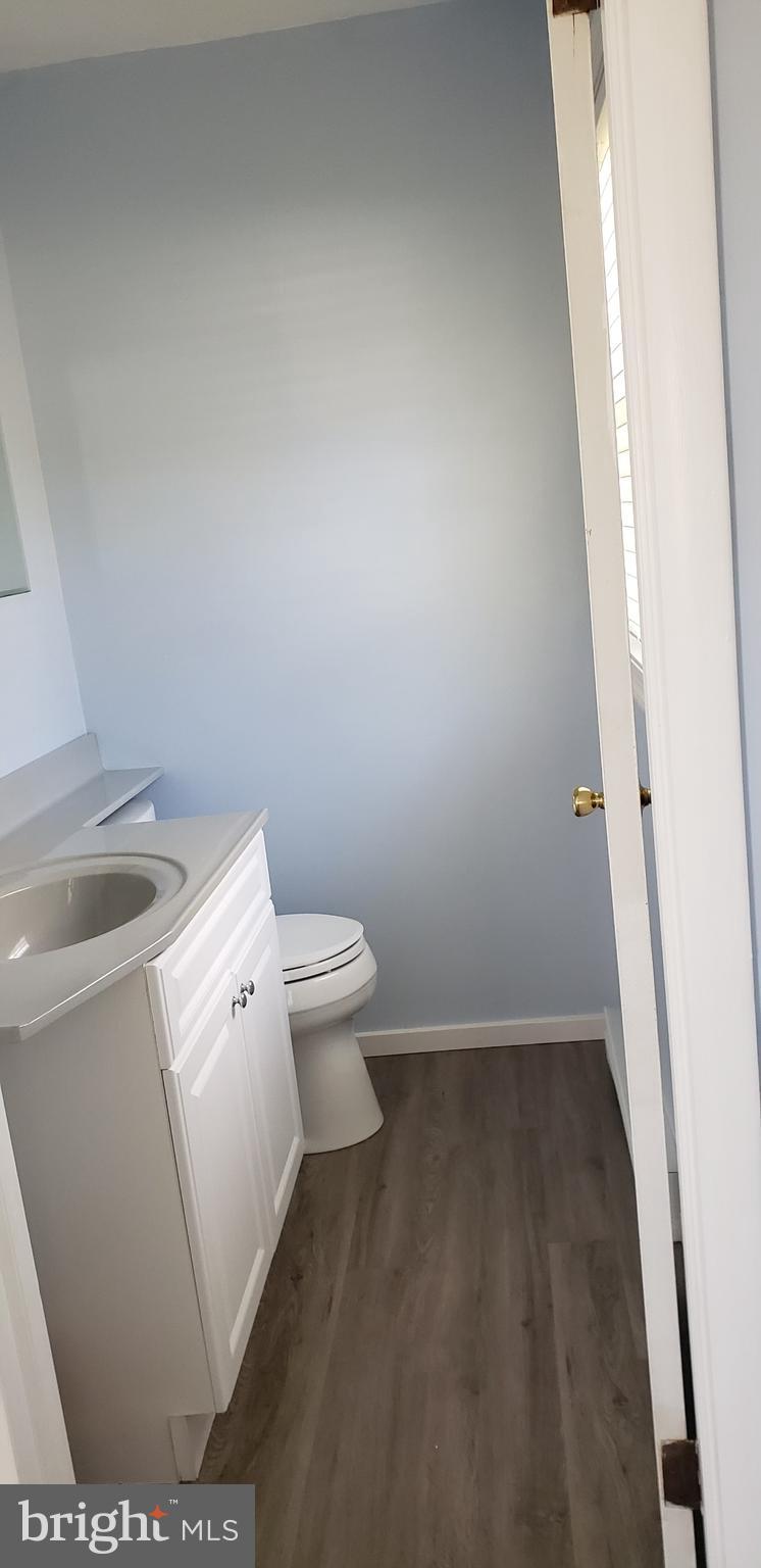12880 Bay Drive Lusby, MD 20657 - Photo 8 of 9 a white toilet sitting next to a sink and vanity