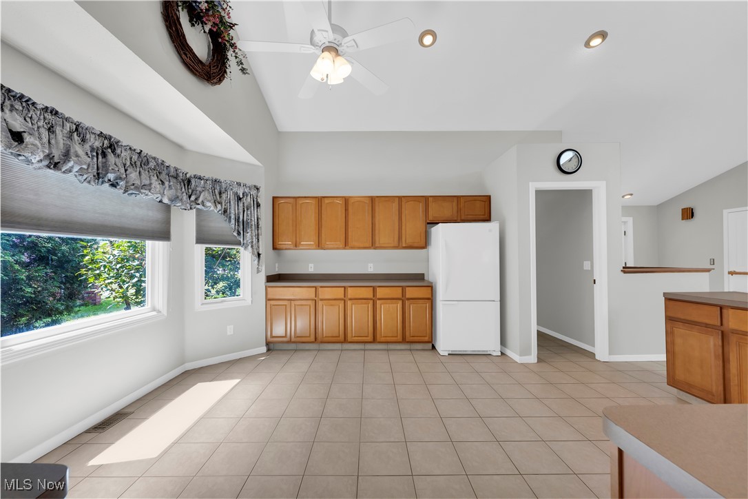 8651 State Road North Royalton, OH 44133 - Photo 13 of 33 Kitchen with freestanding refrigerator, light tile patterned floors, brown cabinetry, ceiling fan, and recessed lighting