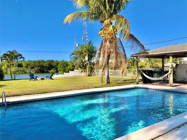 a view of swimming pool with an outdoor seating