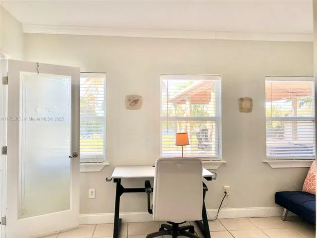 a view of a livingroom with a window and wooden floor
