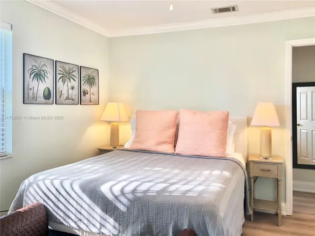 a bedroom with a bed and a painting on the wall