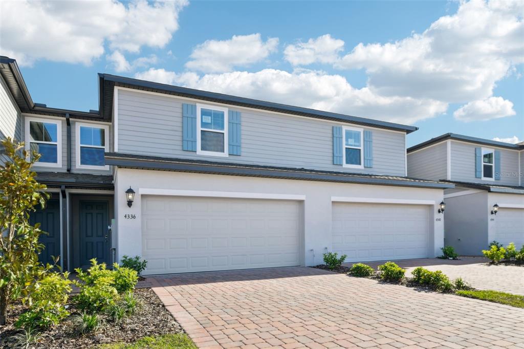 4336 Ranch House Road St. Cloud, FL 34772 - Photo 1 of 1 a front view of a house with a garden