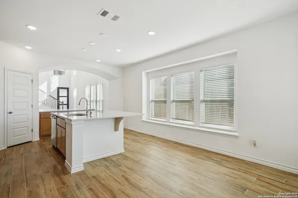 a kitchen with stainless steel appliances granite countertop a stove and a large window