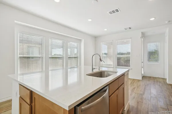 a kitchen with sink attached with living room