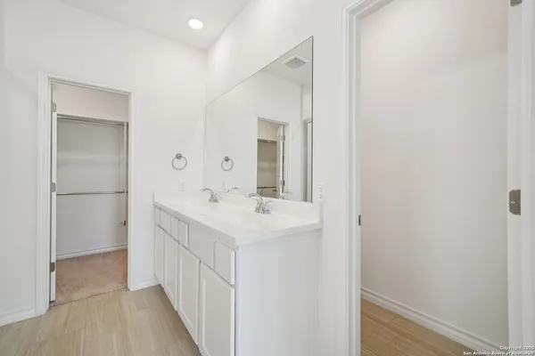 a bathroom with a sink a mirror and a vanity