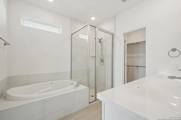 a bathroom with a bathtub and a shower