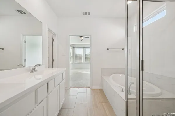 a en suite bathroom with a granite countertop sink a toilet and shower