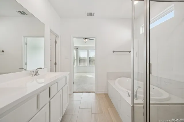 a en suite bathroom with a granite countertop sink a toilet and shower