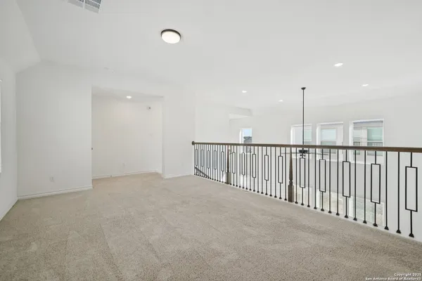 a view of an empty room with stairs