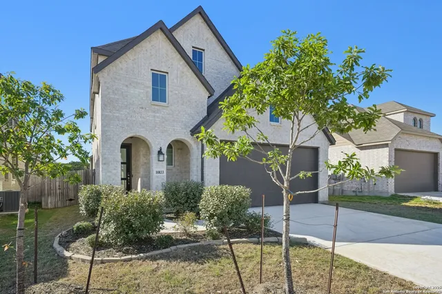 a front view of a house with garden