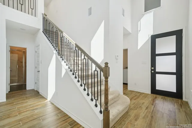 a view of a hallway with wooden floor and entryway