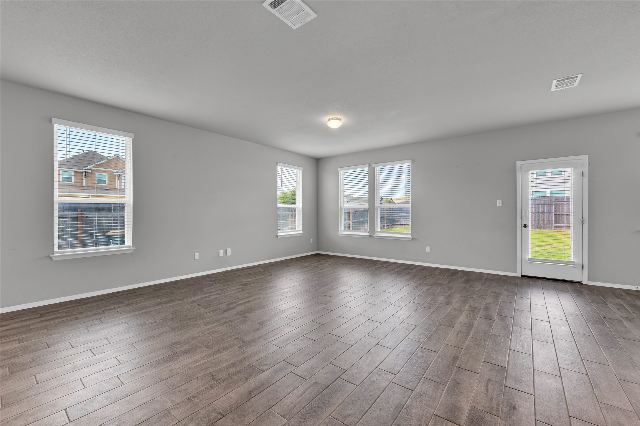 101 Crescent Street Georgetown, TX 78626 - Photo 7 of 39 Living area featuring rich hardwood floors complement a neutral palette in this light-filled great room.