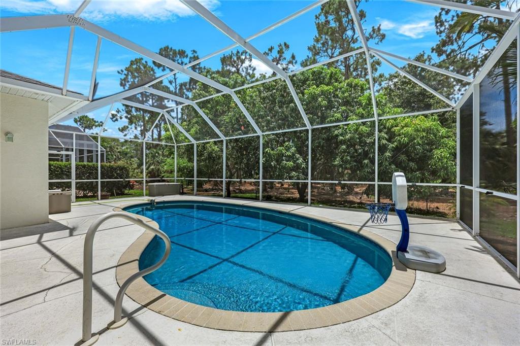 697 Crossfield Circle Naples, FL 34104 - Photo 2 of 18 Swimming pool featuring a patio area and glass enclosure