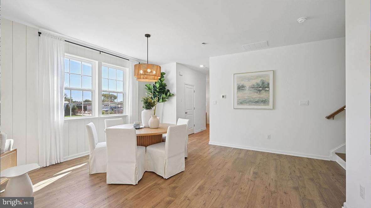 505 Scotty Boulevard, Unit 1302 Rio Grande, NJ 08242 - Photo 16 of 55 a dining room with furniture a chandelier and wooden floor