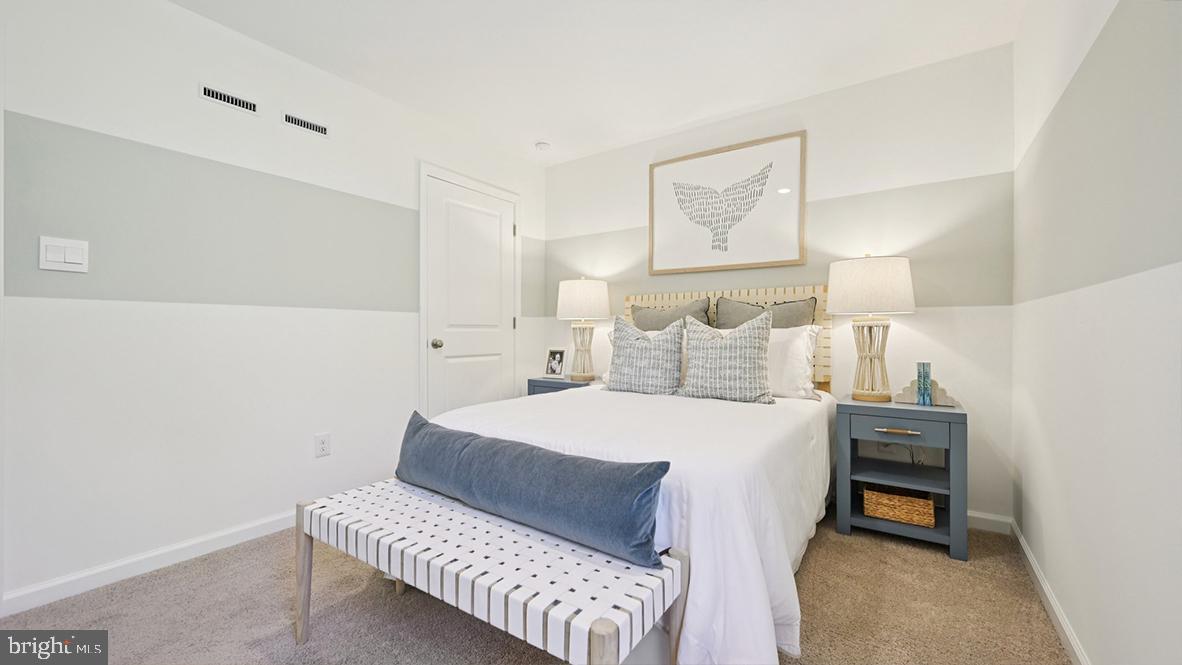 505 Scotty Boulevard, Unit 1302 Rio Grande, NJ 08242 - Photo 27 of 55 a bedroom with a bed and a lamp